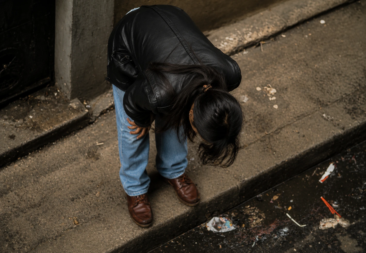 A woman experiencing the physical and psychological weight of chitta dependence